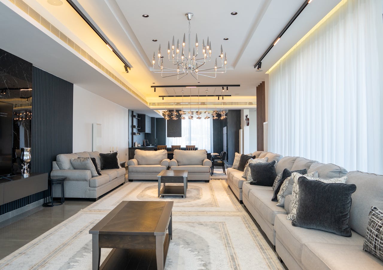 Sophisticated and spacious living room featuring modern décor with chandelier.