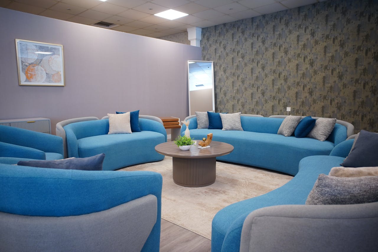 Stylish lounge with modern blue sofas and elegant decor, perfect for cozy gatherings.