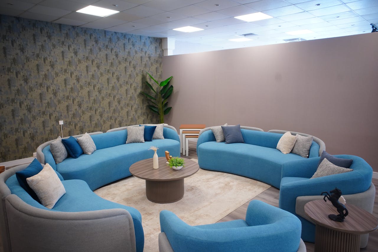 Elegant modern living space featuring stylish blue sofas and cozy decor.